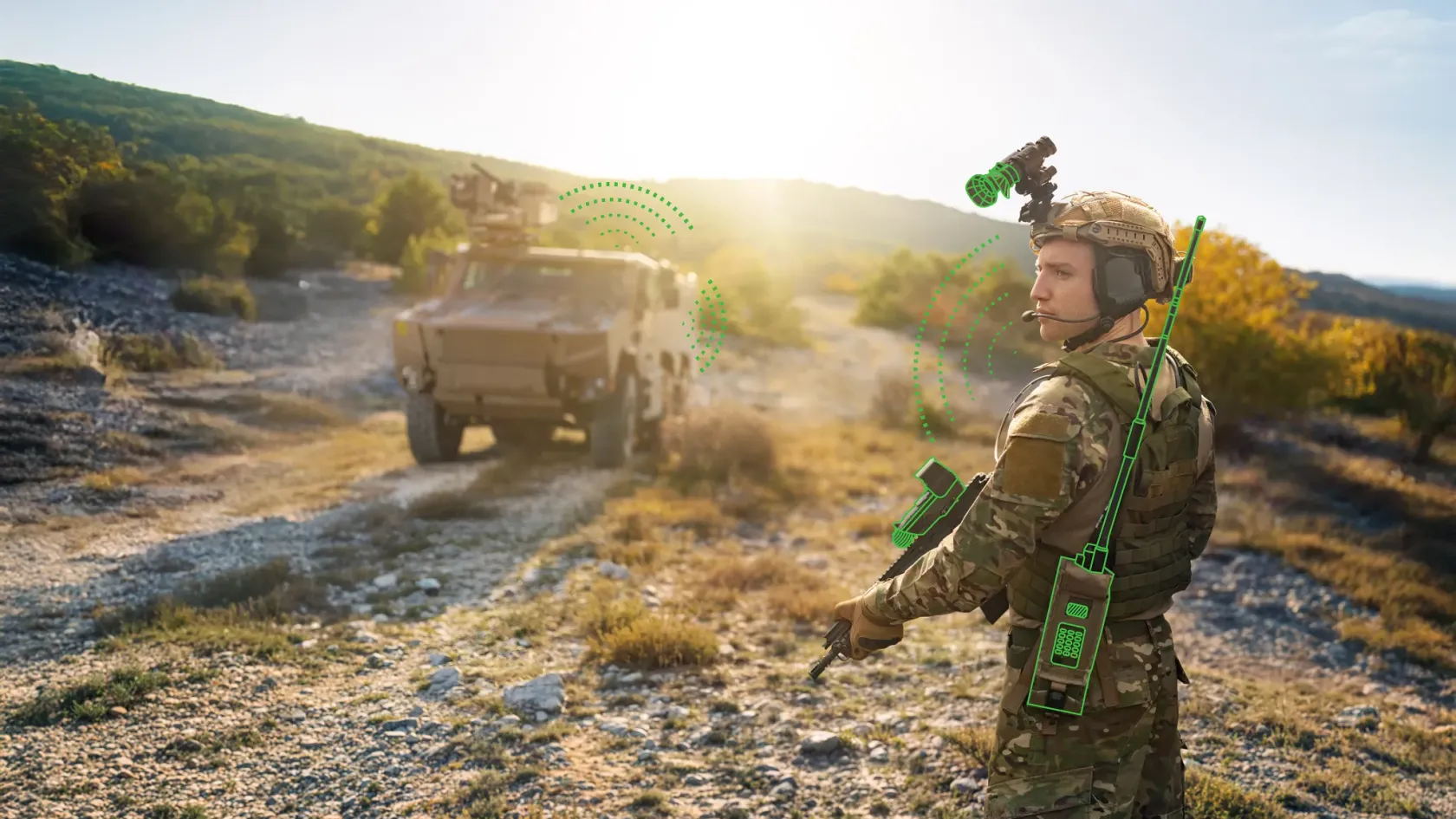 Soldier in daylight with a radio, illustrated signal waves showing a datalink to a vehicle.